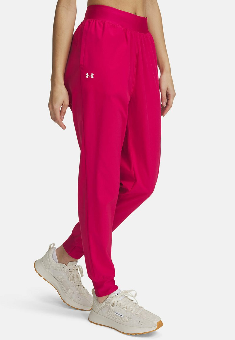 Bright pink athletic pants made of lightweight material with an elastic waistband, featuring a white logo and tapered cuffs.