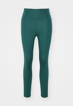 Legíny s vysokým pásom v hlbokej teal farbe, vyrobené z hladkej, elastickej tkaniny. Majú priliehavý strih bez viditeľných švov alebo vzorov.