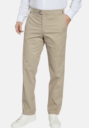 Beige cotton trousers with a straight-leg cut, front pockets, and a single button closure. Styled with white sneakers.