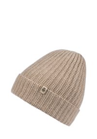 Beige knitted ribbed beanie with folded cuff and small fabric tag featuring a black emblem on white background.