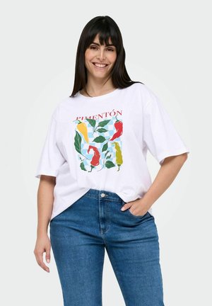 T-shirt en coton blanc avec un graphisme coloré de piments et de feuilles. Coupe décontractée avec des manches courtes, encolure ronde et fente sur le côté.