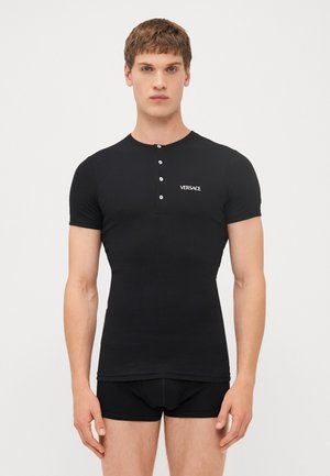 Black short-sleeve henley shirt made of a smooth fabric with five white buttons at the collar, featuring a small Versace logo on the chest.