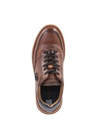 Brown leather shoe with black lace closure, round toe, and rubber sole. Features logo detail on side and textured accents on the tongue.
