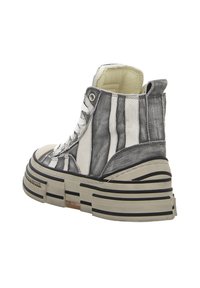 High-top sneaker featuring a black and white striped design, thick platform sole with black accents, and metal eyelets for laces.