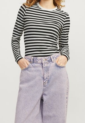 Black and white striped long-sleeve top with a round neckline, paired with high-waisted light purple denim jeans. Textured, casual fit.