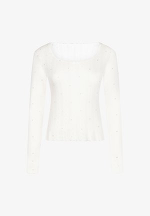 White long-sleeve top with a ribbed texture, featuring scattered small pink heart accents and a scalloped neckline.