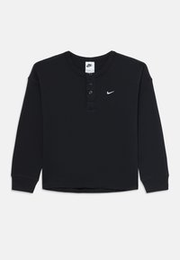 Črni dolgi rokavi waffle-pleteni Nike henley majica s tremi gumbi in majhnim belim Nike swoosh logotipom na prsih.