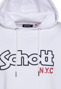 Felpa bianca in cotone, con un grande logo nero "Schott" e "N.Y.C" in rosso, con cordini e una tasca a marsupio frontale.