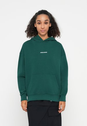 Green hoodie, cotton material, kangaroo pocket, ribbed cuffs and hem, featuring white "PEGADOR" logo on the chest area, relaxed fit.