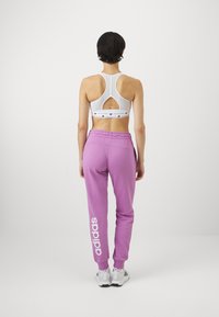 adidas Sportswear ESSENTIALS LINEAR CUFFED - Tréningruha alsók - preloved purple