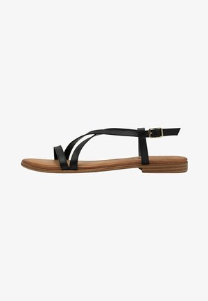 Black leather flat sandal with crisscross straps, adjustable buckle, and a light brown cushioned footbed, featuring a slim, flat sole.