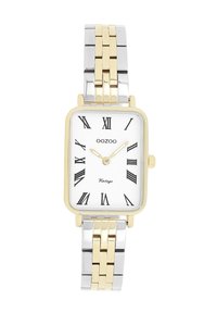 Montre rectangulaire en or et argent avec un cadran blanc, des chiffres romains noirs et un bracelet en métal bicolore. Marque : Oozoo.