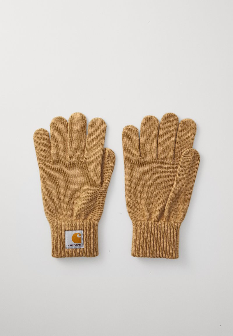 Knit gloves in mustard yellow, featuring a ribbed cuff and a logo patch on the wrist. Smooth texture with five-finger design for dexterity.