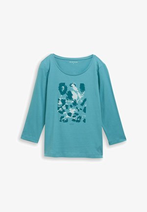 Türkiissinine pika varrukaga särk, millel on sügava kaelusega lõige ja sinise ja valge tooniga graafiline trükk, mis sisaldab abstraktseid kujundeid ja mustreid.