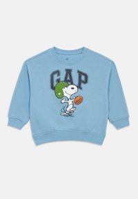 Sweatshirt azul claro feito de mistura de algodão, apresentando uma gráfica do Snoopy com um capacete verde e segurando uma bola de futebol, com punhos e barra canelados.