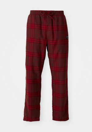 Pantalones de cuadros rojos y marrón oscuro con cintura elástica, hechos de tela suave, con un corte holgado y diseño de pierna recta.