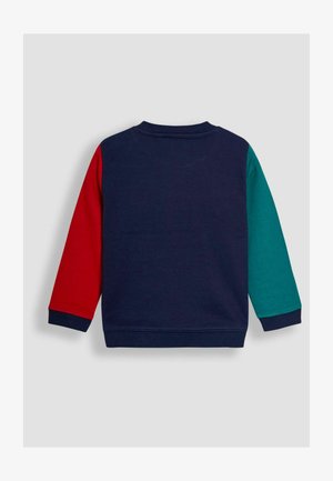 Sweatshirt multicolore avec un corps navy, une manche gauche rouge et une manche droite teal. Matériau en tricot texturé avec des poignets et un col côtelé.