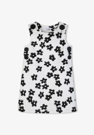 Abito bianco senza maniche con un audace motivo a fiori neri e grandi bottoni neri sulle spalle. Tessuto liscio con taglio dritto.