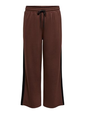 Brūnas sporta bikses ar vaļēju piegriezumu, elastīgu vidukļa joslu ar auklu, melnām sānu daļām un mīkstu teksturētu audumu.