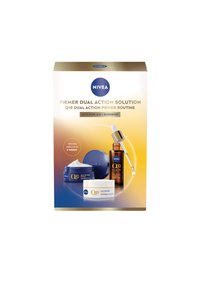 NIVEA Q10 skincare set in a gold-accented box features a blue cream jar, a white cream jar, and a brown dropper bottle.