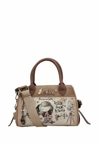 Sac à main beige avec des accents marron, présentant un motif graphique d'une fille en fauteuil roulant, des motifs de texte et une bandoulière amovible.