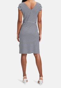 Navy and white striped dress with short cap sleeves and a V-back design. Regular fit, knee-length, made from a soft, stretchy material.
