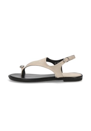 Sándala de cuero beige con anillo para el dedo del pie, correa ajustable en el tobillo y suela negra. Presenta un acabado suave y un diseño minimalista.