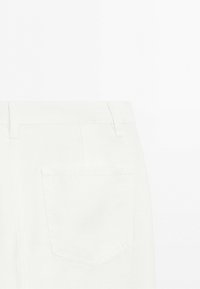Back view of white pants showing belt loops and a single back pocket on a plain white background.