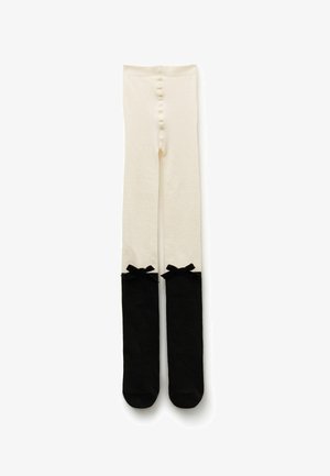 Knee-high tights feature a cream upper section and black lower section with decorative black bows at the tops. Soft, stretchy material.