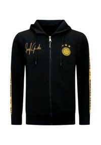 Zwarte hoodie met rits en gele accenten, voorzien van een capuchon, manchetten, voorzakken en tekst/logo op de borst en mouwen. Zachte stoftextuur.