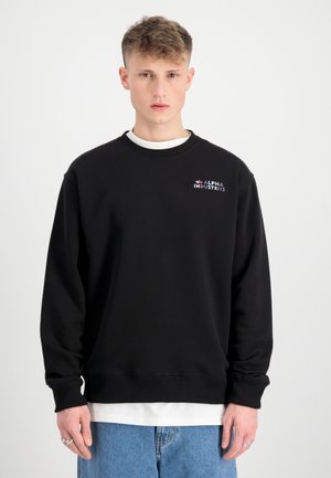 Schwarzer Sweatshirt mit Rundhalsausschnitt, langen Ärmeln, gerippten Bündchen und Saum. Verfügt über ein mehrfarbiges "Alpha Industries"-Logo auf der Brust.