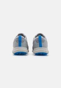 Gray athletic shoes featuring a textured upper, blue accent on the heel, and a spiked blue outsole for traction.