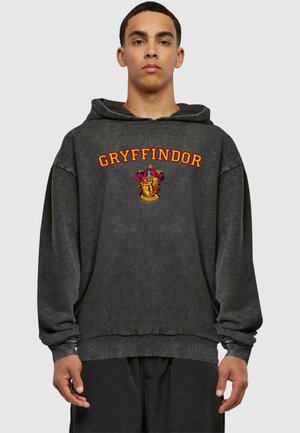 Sort hættetrøje med "Gryffindor" i orange bogstaver og et broderet våbenskjold. Afslappet pasform med ribkantede manchetter og kant.