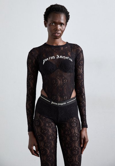 Bodysuit en dentelle noire avec manches longues et côtés découpés, arborant le texte "Palm Angels" en broderie blanche sur la poitrine et la ceinture.