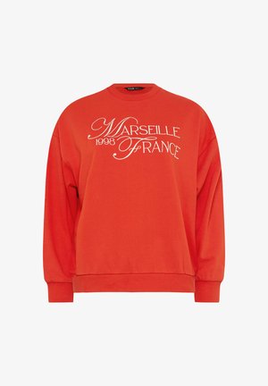 Jasnopomarańczowa bluza z białym, kursywowym napisem "Marseille 1998 France" na przodzie, z długimi rękawami oraz ściągaczami na mankietach i dole.