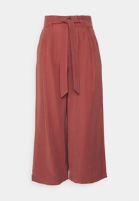 Rust-colored wide-leg pants with a belted waist, featuring a smooth texture and pleats along the front for added detailing.