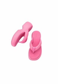 Infradito rosa realizzati in materiale gommoso durevole, caratterizzati da una suola testurizzata, una fascia tra le dita e un design curvo della soletta per il comfort.