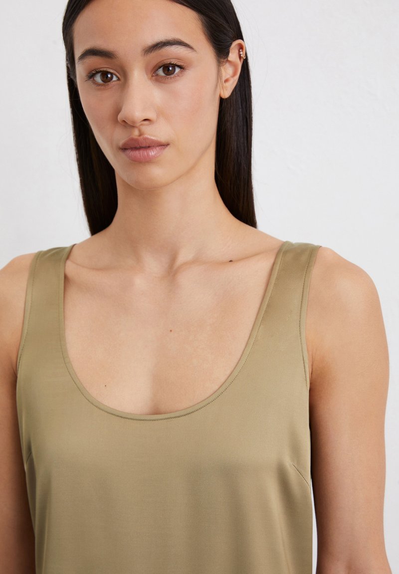 Olivgrünes ärmelloses Top mit weitem Rundhalsausschnitt und weichem, glattem Stoff. Schlichtes Design ohne sichtbare Muster oder Akzente.