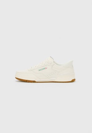 Off-white Skechers tennarit, joissa on kumipohja, sivureikänauhoitus, nauhakuja ja pieni vihreä ja punainen Skechers-logo sivupaneelissa.