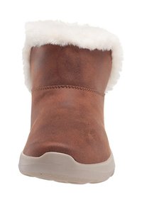 Brown faux leather boot with white fur trim at the top, textured surface, rounded toe, and a light-colored rubber sole.