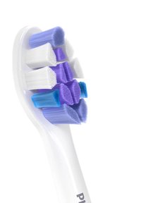 Tandenborstel met een witte handgreep en afwisselende borstelkleuren: wit, blauw en paars. De borstels zijn zacht met verschillende hoogtes en configuraties.