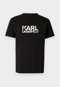 Μαύρο βαμβακερό t-shirt με κοντά μανίκια, με μια μεγάλη λευκή γραφική παράσταση του λογότυπου "KARL LAGERFELD" στο μπροστινό μέρος. Κλασικός σχεδιασμός με λαιμό κορώνα.