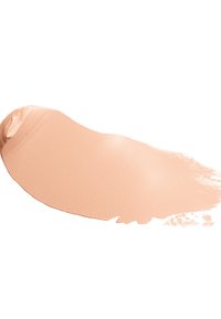 Tan liquid foundation with a creamy texture, applied in a smooth, curved stroke on a white background. Shows a subtle sheen in color.