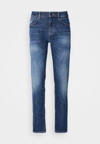 Denim jeans in medium blue with a faded finish, five pockets, and subtle distressing on the fabric. Straight-leg cut.