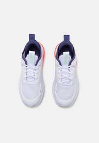 White athletic shoes featuring a mesh upper, contrasting navy and neon orange accents, padded collar, and pull tab for easy wear.