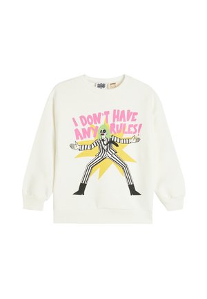 Sweatshirt blanc avec un graphique d'un personnage aux cheveux verts, vêtu d'une tenue rayée noir et blanc, et le texte "JE N'AI AUCUNE RÈGLE !"