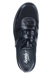 Black sneaker with leather-like texture, double Velcro straps, rounded shape, padded collar, and branded insole.