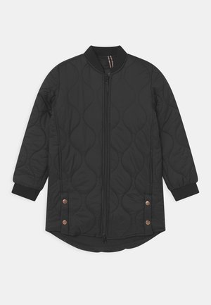 Black quilted jacket with a rounded hem, ribbed collar and cuffs, and copper-colored snap buttons at the bottom. Zipper front closure.