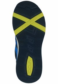 Suola di scarpa con una superficie in gomma nera testurizzata, un accento "FLEX ZONE" blu e giallo e un logo VADO prominente al centro.