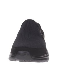 Chaussure de sport noire avec une tige en mesh, bout arrondi, semelle rembourrée et détails texturés. Dispose d'un arrière lisse et flexible.